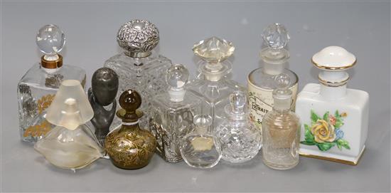 A silver-mounted cut glass toilet bottle and a group of glass perfume bottles, including a Dali Lips and Nose frosted example